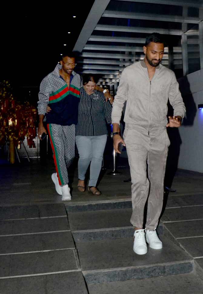 Brothers Hardik Pandya and Krunal Pandya at a dinner outing with their mother. The brothers were twinning in white shoes for the night.