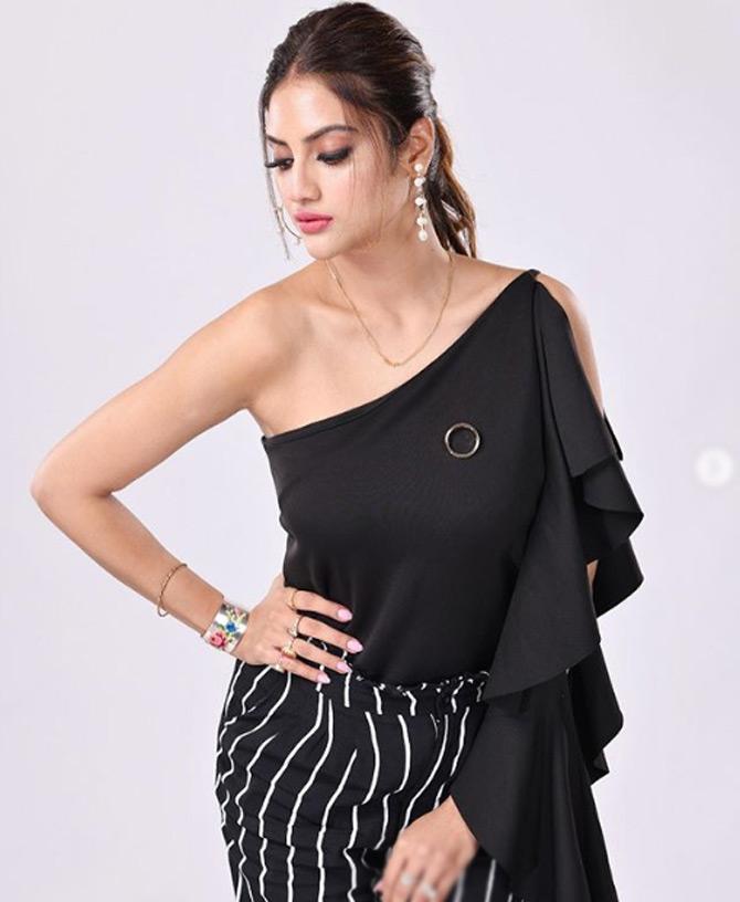 Nusrat Jahan looks fab in a one-shoulder crop top and black and white striped pants. While sharing this picture from one of her photoshoots, Nusrat captioned it: If I was meant to be controlled, I would have come with a remote...!
