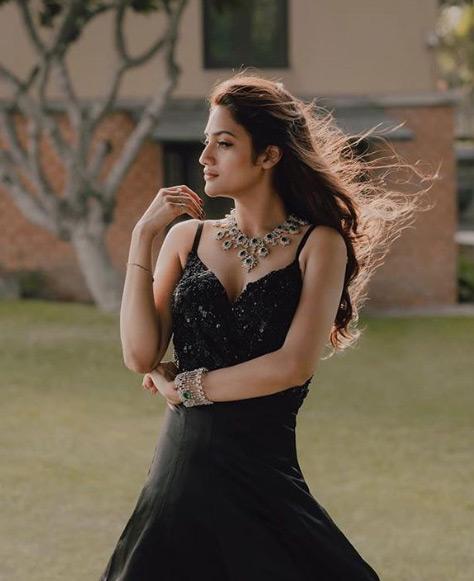 Nusrat Jahan looks poised and poignant as she shines in a black dress during one of her photoshoots. Nusrat completed her look with a beautiful neckpiece and leaves her long tresses open