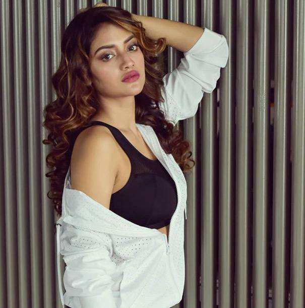 Nusrat Jahan shared this picture from her gym diaries. Sporting black sportswear, Nusrat Jahan completes her gym look with a white jacket. Nusrat captions this one: Wear your confidence every day!