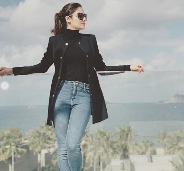 In pic: Nusrat Jahan stuns in a black top and blue denim she poses amidst a scenic beauty during one of her vacations. Jahan completes her look with a black overcoat