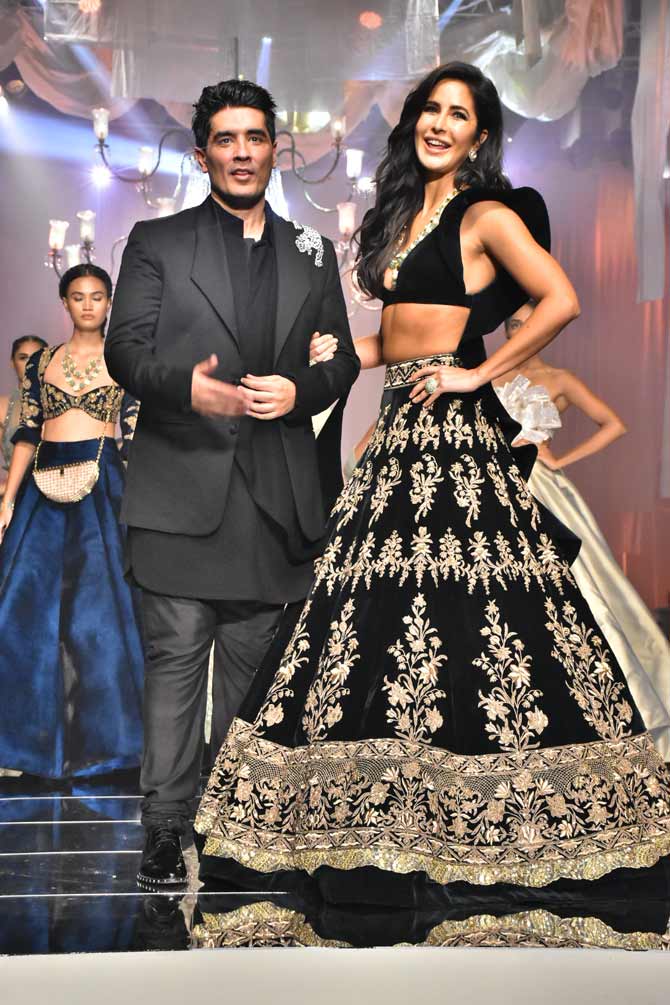 Katrina Kaif turned showstopper for the show that opened the week-long fashion event that entered its 20th year. Wearing a dark green, heavily embellished, velvet lehenga and a co-ord blouse, the Ek Tha Tiger actress completed the look with open soft waves and nude makeup. Her neckpiece with a plunging blouse added an oomph factor to her look.