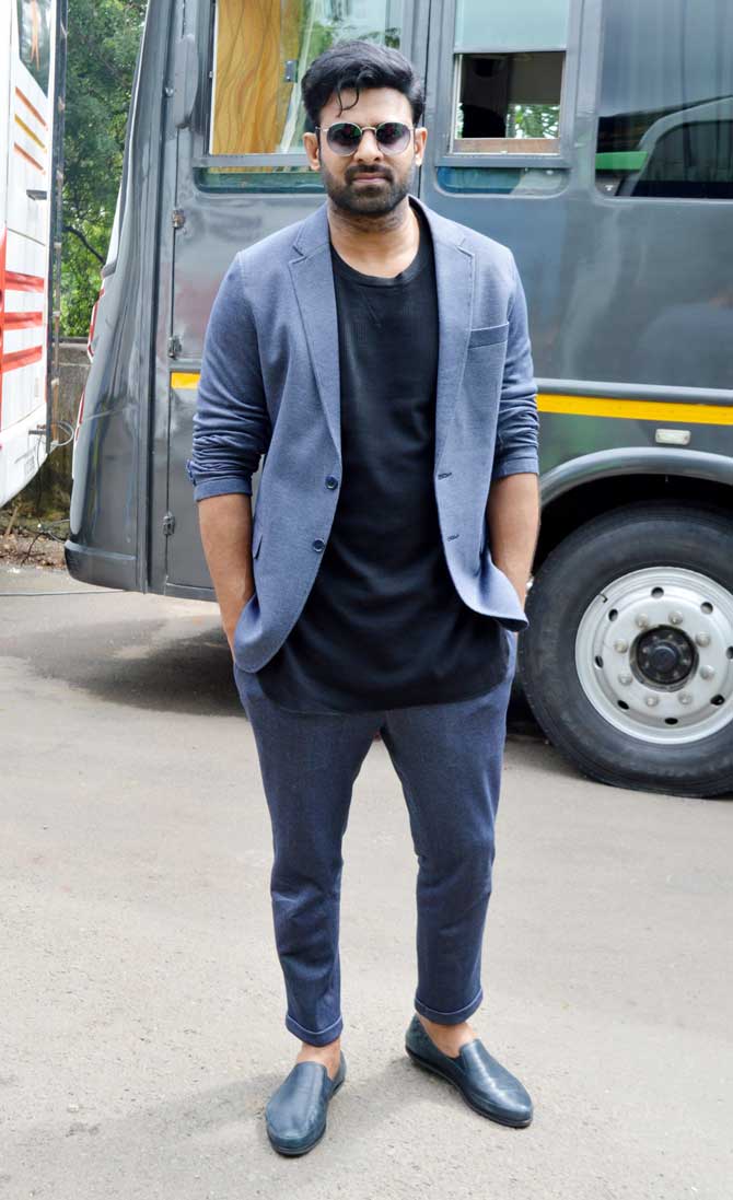 Speaking of Prabhas, the Baahubali actor looked dapper in his black t-shirt, blue trousers, and jacket. In Saaho, Prabhas will be seen in a completely new avatar after Baahubali. The actor will be seen fighting rain, dust, car, and bike and is leaving no stone unturned to perfect his action sequences. The actor has spent as many as 10 hours at a stretch to master the new stunts.