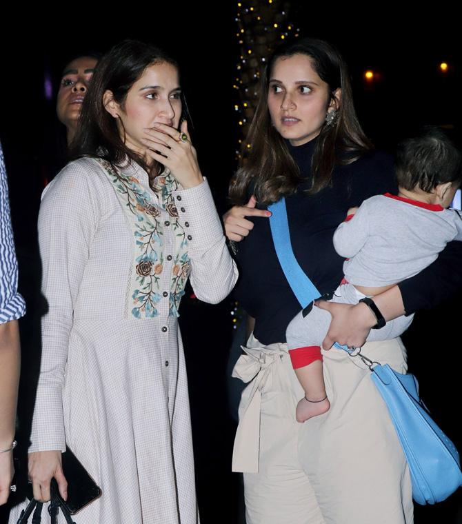 Sania Mirza was looking stylish on the night in a black full sleeves top and cream coloured shorts. She was also doing the balancing act with Izhaan Mirza Malik in one hand.