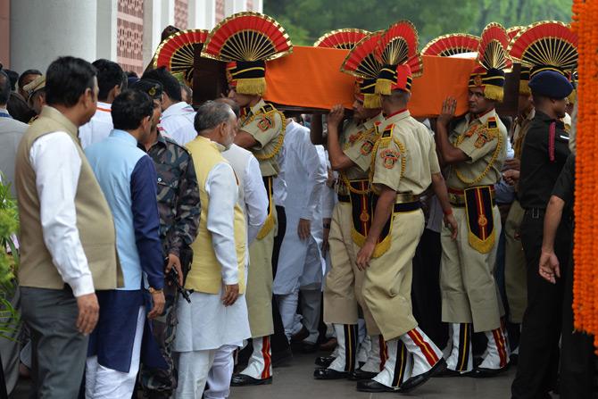 In pic: Police officers carry the mortal remains of former Finance Minister and BJP leader, late Arun Jaitley as they arrive at Bharatiya Janata Party (BJP) headquarters in New Delhi