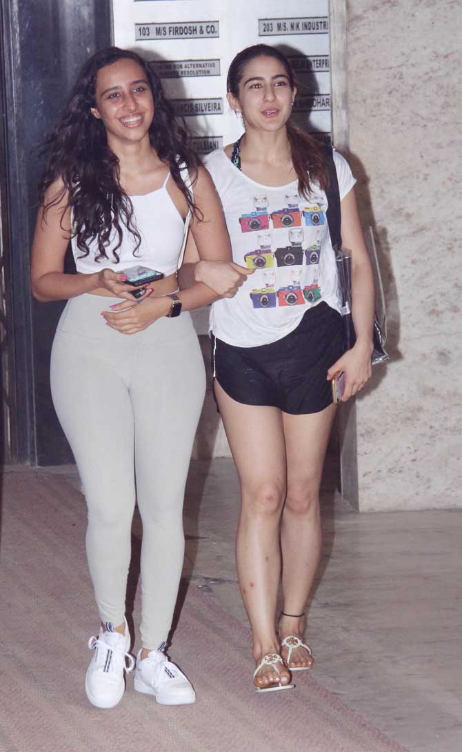 The trio - Varun Dhawan, Sara Ali Khan and Ganesh Acharya seem to be rehearsing for a dance number from the movie. The actress sported a yellow crop top, paired with black yoga pants, Varun is seen wearing the same coloured t-shirt. While both are seen wearing yellow, Varun 'accused' Sara of copying the colour during rehearsals.