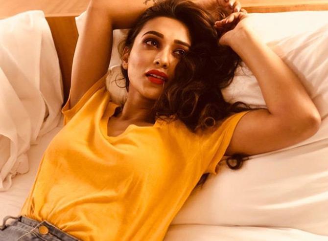 While sharing this picture from one of her photoshoots, Mimi Chakraborty is seen donning a shorty sleeve yellow t-shirt. 