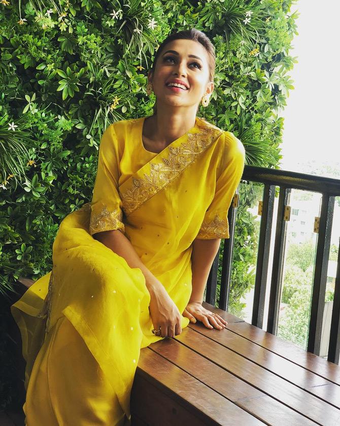 In this photo, Mimi Chakraborty looks fresh like a sunflower in a yellow churidar as she gets cheerful while being caught in a candid moment. 