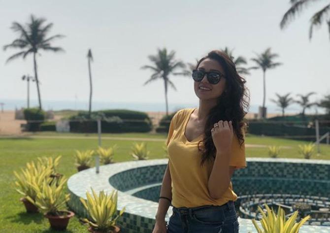 In picture: Mimi Chakraborty stuns in a simple yellow top as she poses amidst a scenic backdrop during one of her vacations. Mimi completes her casual look with a pair of denim and leaves her hair open.