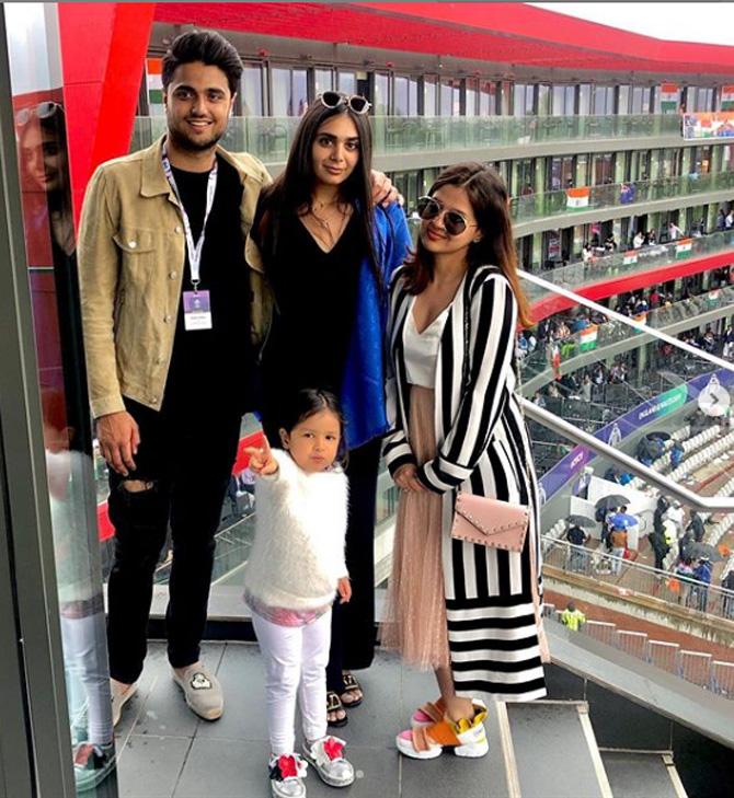 In picture: Sakshi Dhoni with Ziva Dhoni and Kabir Bahia during India's World Cup match. Sakshi Dhoni looks chic in a zebra printed jacket, peach skirt and a white top.