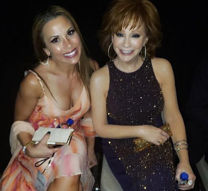Mickie James shared this picture with veteran country singer Reba McEntire and captioned it, 'Please excuse me whilst I fan girl on the inside. Had the honor of meeting this #LivingLegend @Reba last night at @celebfightnight and was in complete awe of her true & genuine soul. Not only an idol of mine and one of the biggest inspirations of my music, but the #queenofcountry herself! Thank you for all that you do and for being so humble, gracious, and kind. #womenshistorymonth #womeninspiringwomen #reba #country #idol #legend #Queen #inspiration #countrymusic #singersongwriter #celebrityfightnight #wwe #wweraw #wrestlemania #mondaynightmickie #gaw'
