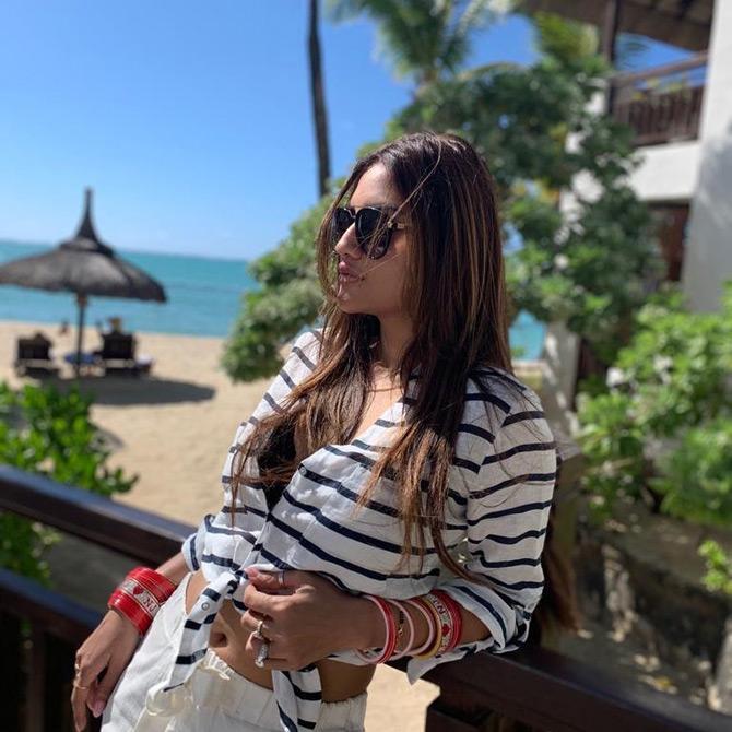 While sharing the first couple of pictures from her honeymoon dairies, Nusrat Jahan looked like a true diva. Nusrat sported a white crop top with black stripes as she posed amidst the backdrop of the picturesque beaches of Mauritius. While sharing this stunning picture of herself, Nusrat wrote: Paradise has never been abt places, it exists in moments, in connection, in flashes across time...!