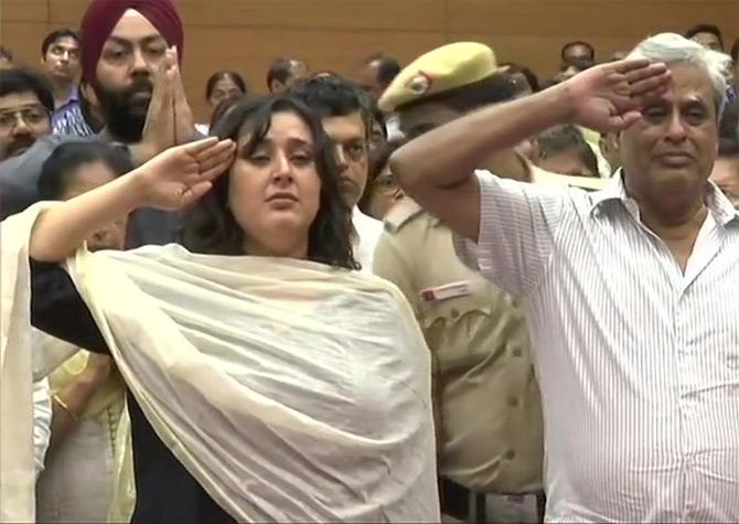 In pic: Sushma Swaraj's daughter Bansuri Swaraj and husband Swaraj Kaushal salute as state honours are accorded to late Sushma Swaraj before the final rites at BJP headquarters in New Delhi.