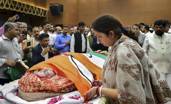 Union Minister Smriti Irani pays homage to former external affairs minister Sushma Swaraj minutes before her mortal remains left the BJP headquarters to Lodhi crematorium for the final rites in New Delhi.