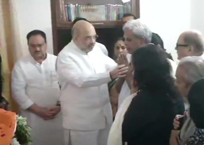 In pic: Home Minister and BJP president Amit Shah offers his condolences to Swaraj Kaushal, husband of late BJP leader Sushma Swaraj.
