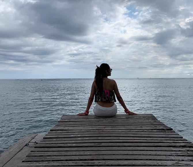 Nusrat Jahan poses in front of the picturesque beach during her honeymoon trip to Mauritius as she captioned this stunning picture as Every sunset promises a reset...!