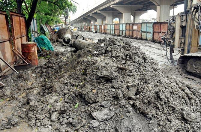 Debris from ongoing Metro 3 work falls into drain along the road at Kalanagar, Bandra East