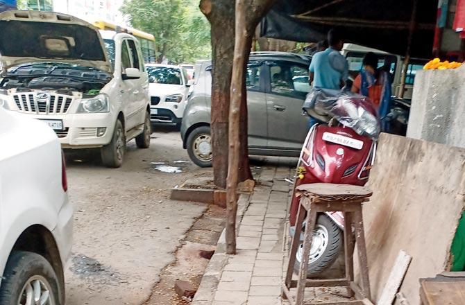 Garages and auto service centres on the main road near Sangeeta Enclave in Mulund, not only occupy the footpath, but also the road. Repair and servicing work are carried out on the road  