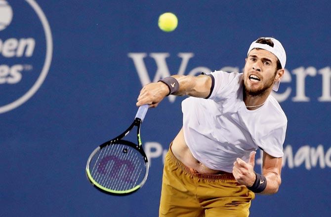 Karen Khachanov of Russia serves to Nick Kyrgios of Australia during the Western & Southern Open at Lindner Family Tennis Center