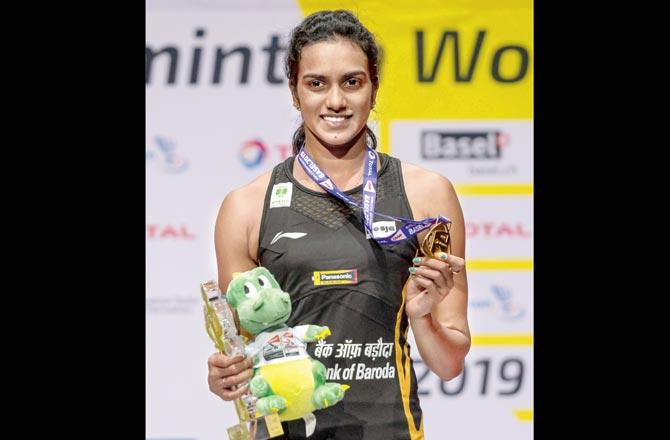 PV Sindhu with her gold. Pic/AFP