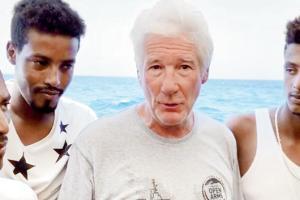 Richard Gere delivers food to migrants stuck aboard ship