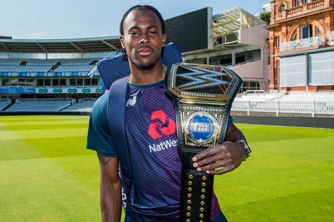 England cricketer Jofra Archer poses with the WWE Championship belt