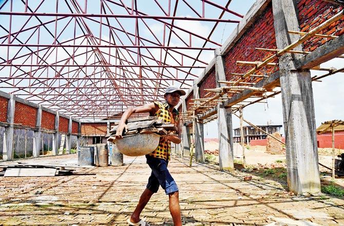 A labourer works on the site. Pics/AFP