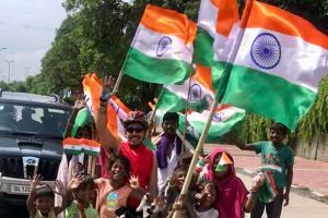 Robert Vadra poses with flag sellers on Independence Day during workout