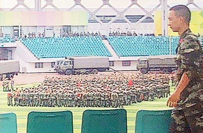 Inside, Chinese military personnel gather. Pics/AFP