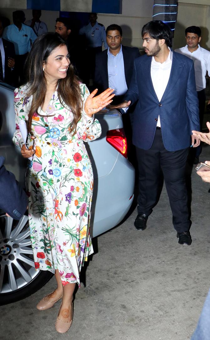 In photo: Isha Ambani caught in a light moment as her younger brother Anant Ambani escorts her to the car