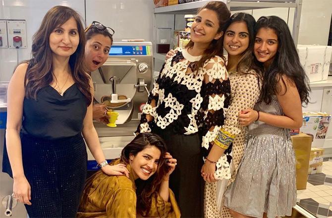 In photo: Isha Ambani looks pretty in a multi-coloured printed cotton kurti and plain white cropped pants as she poses for a picture with her celebrity friends including Priyanka and Parineeti Chopra