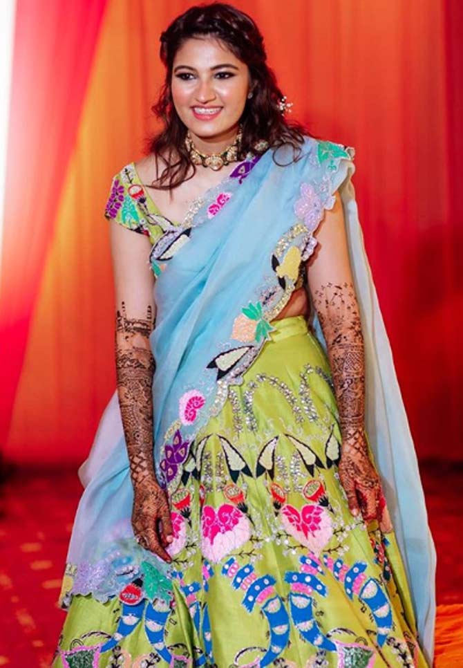 Anam Mirza looked radiant in a colourful lehenga with the colours red, blue, green, yellow, pink and white with a blue dupatta.