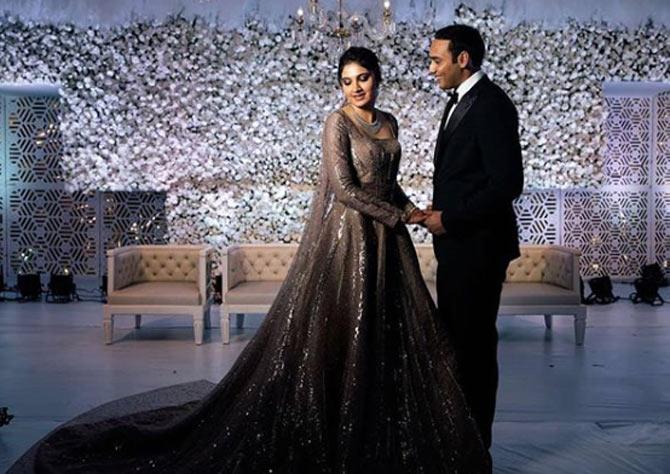 Anam Mirza and her husband Asaduddin at their wedding reception. Anam wore a beautiful grey glittery gown while Asad looked smart in a tuxedo