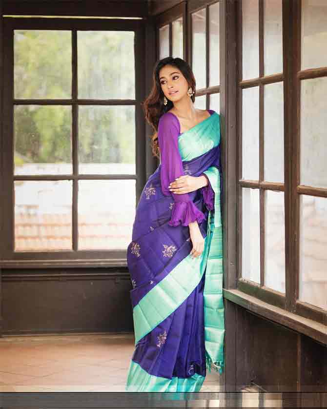 2018 Femina Miss India Anukreethy Vas is a college student from Tamil Nadu. She is pursing BA in French Literature from the prestigious Loyola College in Chennai. In this photo, she gives a spunky mix-and-match feel to a Kanjivaram sari by teaming it with a long, puff-sleeved blouse.