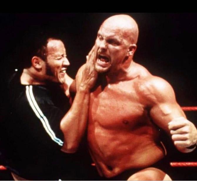 Steve Austin is known as one of WWE most loved and famous superstars. He was notable in the 90s for his on-screen feuds with WWE CEO Vince McMahon and former WWE superstar Dwayne 'The Rock' Johnson.
Stone Cold Steve Austin shared a throwback photo with rival-turned-friend Dwayne 'The Rock' Johnson. He captioned it: Takin’ Care of Business w @therock. @wwe #wwe #tbt