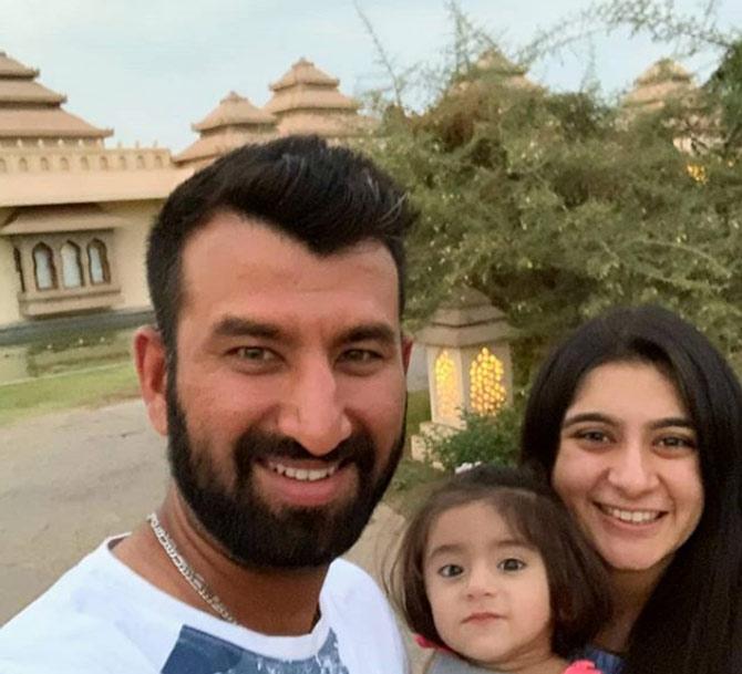 Indian batsman Cheteshwar Pujara shared this adorable picture with wife Puja and their daughter during a holiday and wrote, 'The best holiday picture we could get with the toddler refusing to stay still! #happyvibes'