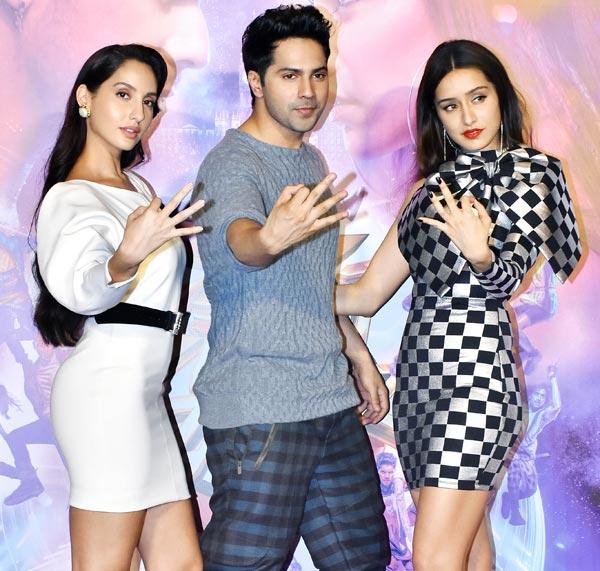 Varun Dhawan wore a grey sweatshirt and black and blue checkered pant, while Shraddha Kapoor looked stunning in her white checkered mini dress and Nora Fatehi wore white dress with a black belt.