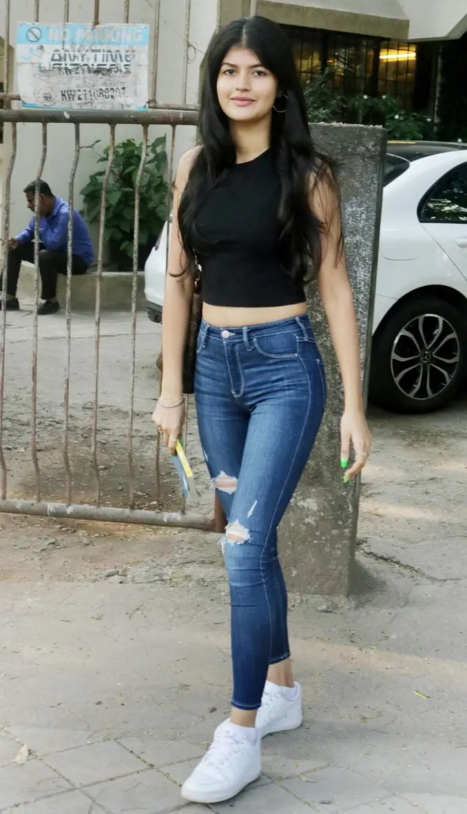 Anjini Dhawan was clicked at a popular salon in Juhu, Mumbai. The young star kid wore black crop top and distressed denim with white sneakers as she exited the salon. All pictures/Yogen Shah
