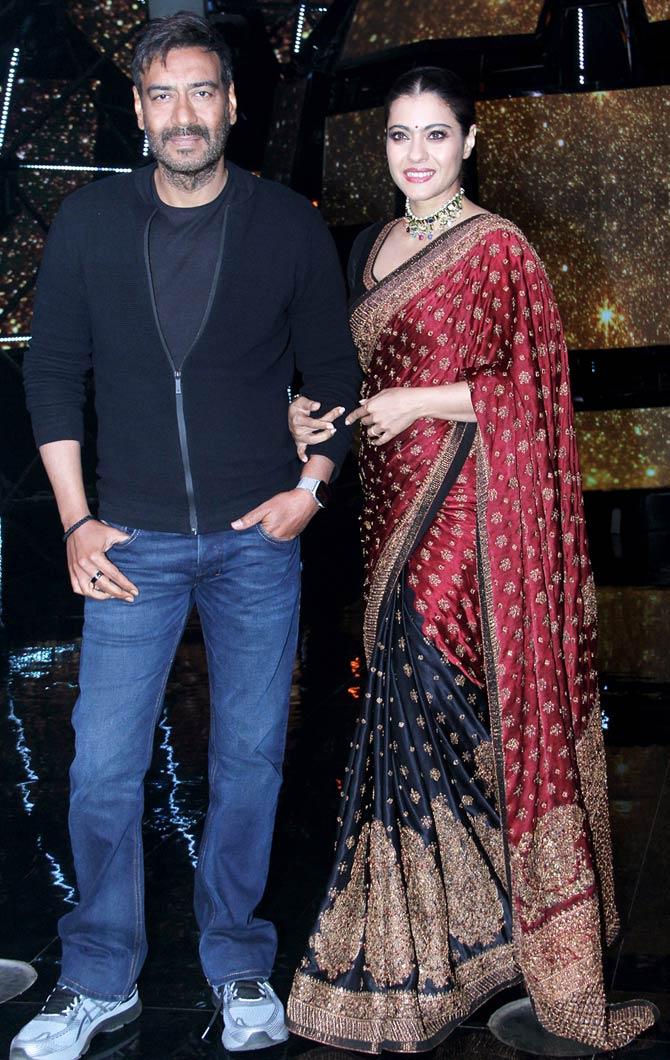 While Ajay Devgn opted for a simple casual attire - black tee, black jacket, blue jeans and shoes, Kajol looked glamourous in a heavy-embroidered saree, paired with a lovely neckpiece.