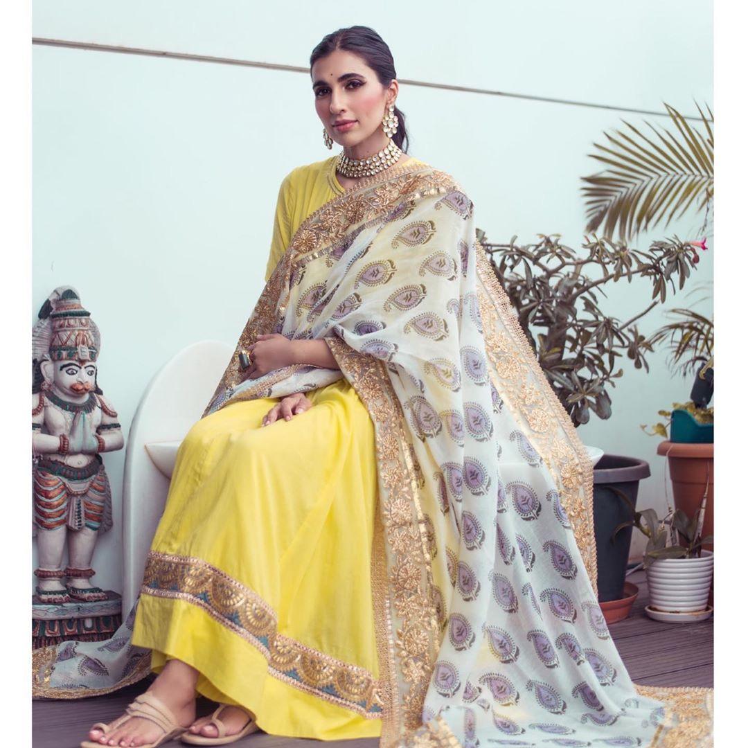 The dimpled beauty adorns a gorgeous yellow Anarkali in this photo with a chanderi dupatta adding an element of grandeur to her look