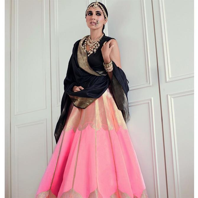 She sizzles in a typical festive look where she styles her black and pink Raw Mango lehenga with a maathapatti and statement necklaces