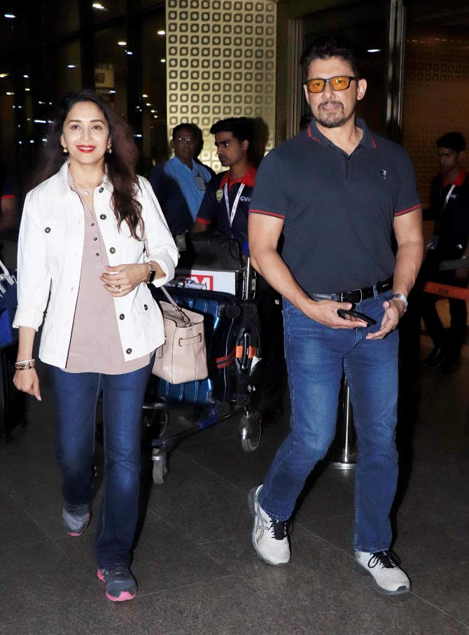 Madhuri Dixit Nene along with husband Shriram Nene was spotted at the Mumbai airport. The Dhak Dhak girl and husband return from their holiday. All pictures/Yogen Shah