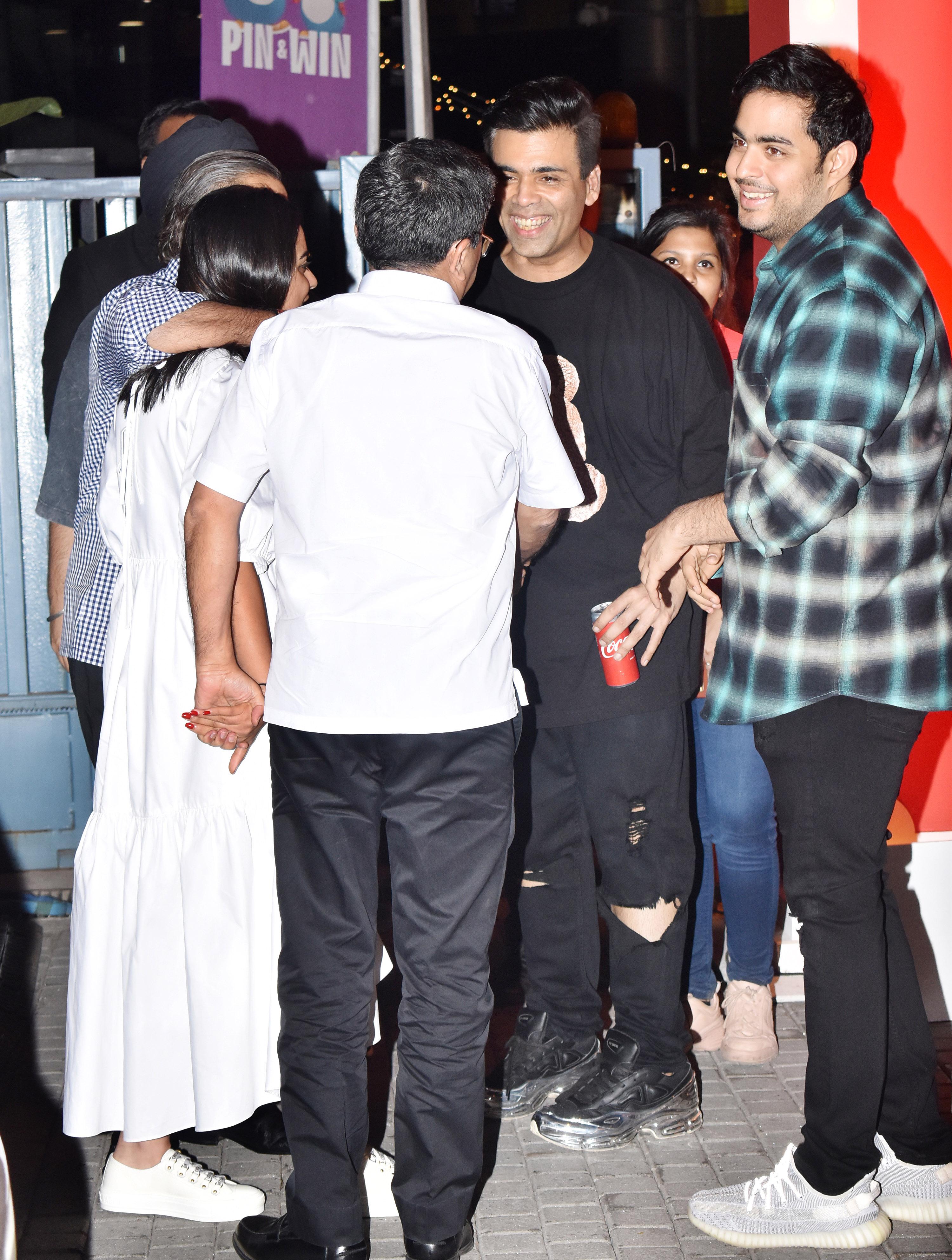 In photo: Karan Johar shares a hearty laugh with Mukesh, Akash and Isha Ambani after the event in BKC