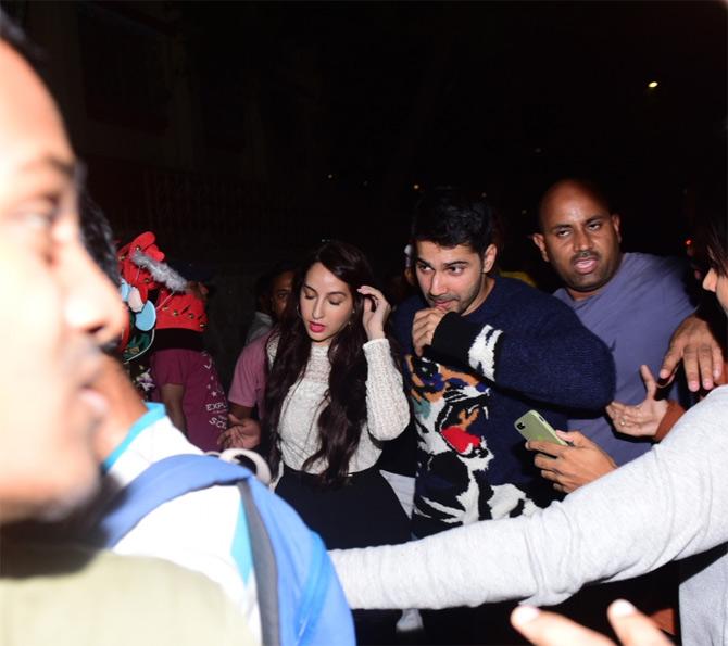 Varun Dhawan took his Instagram to acknowledge the photographers who helped him and Nora to get out from the major crowd.