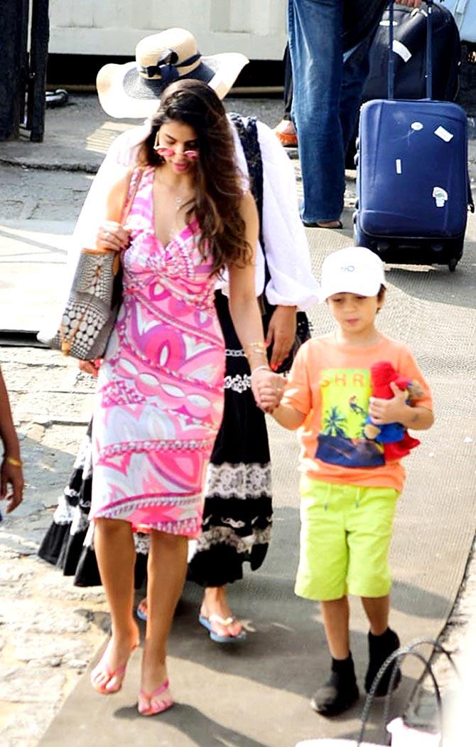 Suhana Khan opted for a pink printed dress, while little AbRam looked cute in an orange tee and fluorescent shorts.
In picture: AbRam holds his sister's hand as they hop on their jetty.