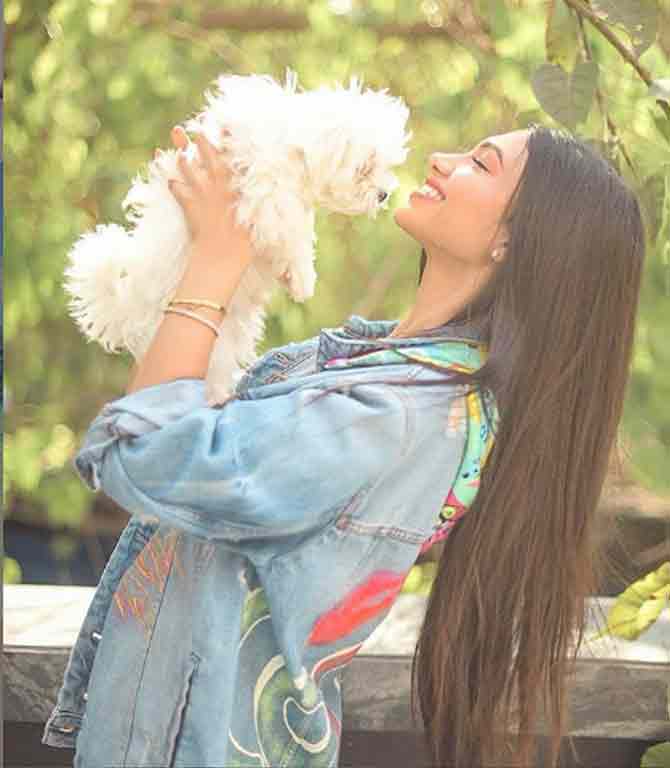 Here, Panday is seen in denim, introducing her recently-adopted pet pup to her followers. She captions, 