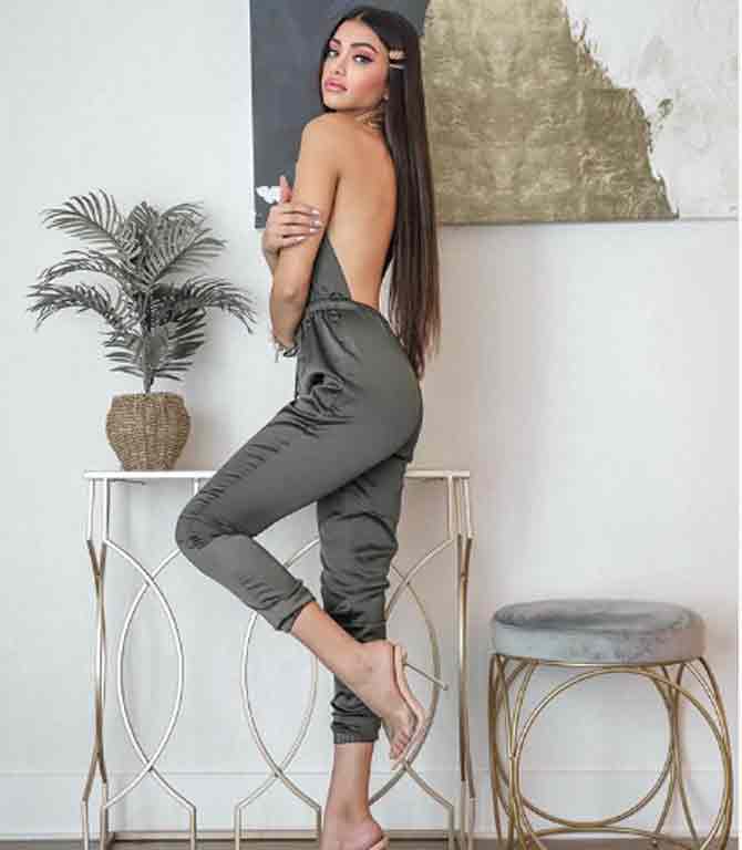 In this picture, she looks hot in a grey halter-neck jumpsuit and transparent stillettos with her hair let loose