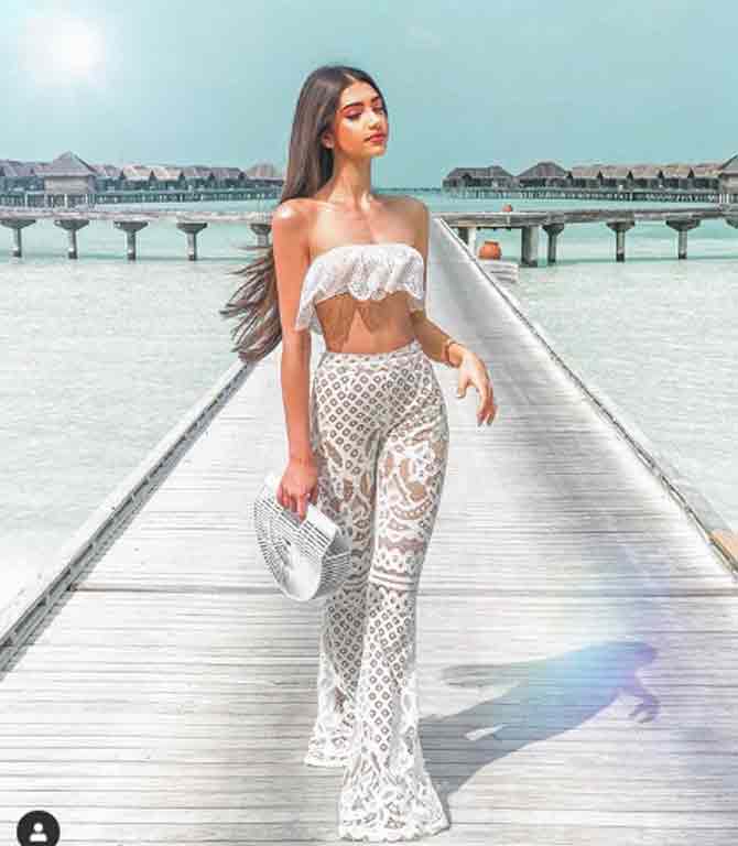 In another beachside photo, she is giving the sun a run for money in a white crop top and lacy pants while vacationing in Maldives.