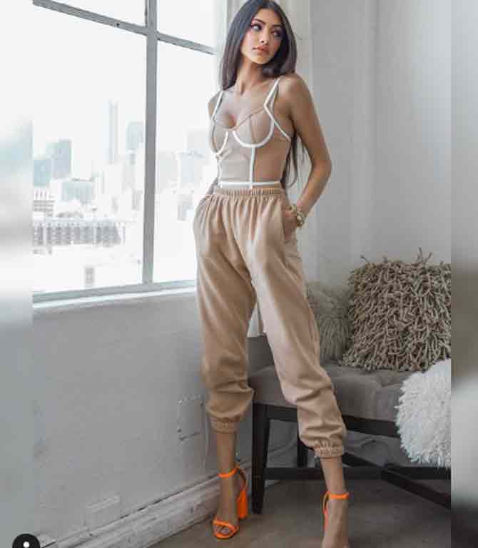 Panday looks gorgeous in this beige corset top and joggers with bright orange heels.
