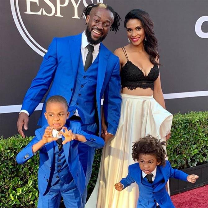 Former WWE champion Kofi Kingston shared this picture with his wife and kids during the ESPY awards night and wrote, 'We had a great time at the #espys tonight! It was even more amazing to share the experience with my family! We all had a such an awesome time; especially the boys, lol. Even had a special appearance from @titusoneilwwe! And a BIG shout to @davidalanstyle for coming through with the suits! #trueblue. Also, my wife is hot! #espn #wwe #davidalan #espys2019 @yogimommylife